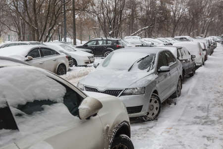 Cars in the parking lot on a winter day in the snowの写真素材