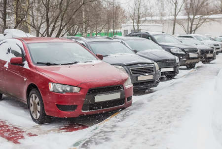Cars in the parking lot on a winter day in the snow