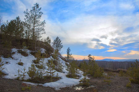 Beautiful winter landscape with mountains forest and sky at sunset