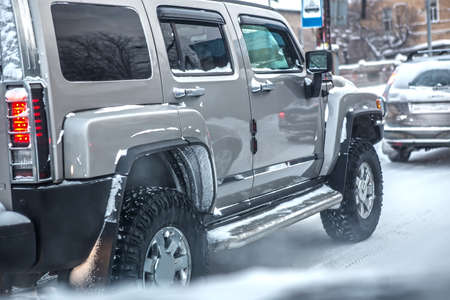 SUV moving in the winter on a city street in the snow