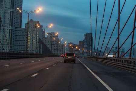 traffic on the bridge in the evening along the residential areaの写真素材