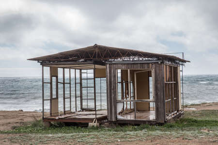 Ruined house by the sea on the beachの写真素材