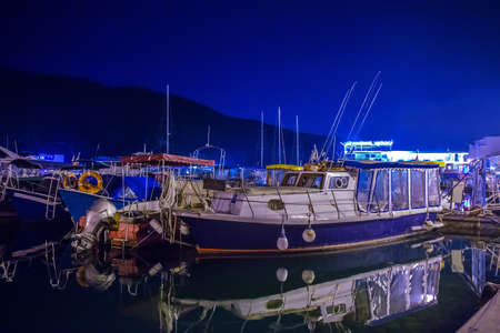 powerboats and ships in the parking lot at the pier at nightの写真素材