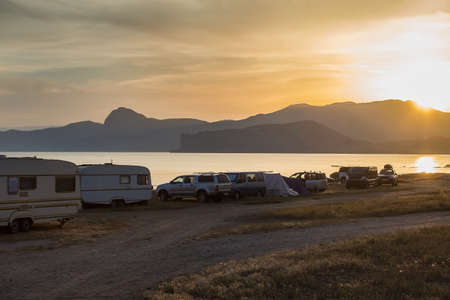 Camping cars on the beach at sunsetの写真素材