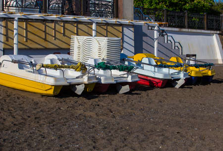 plastic walking boats on a ply sandy sea beachの写真素材