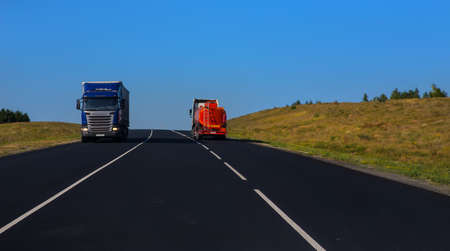 Trucks moving on a country highwayの写真素材