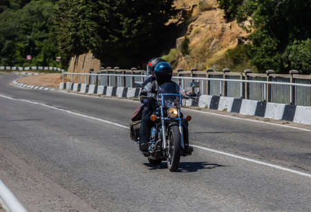 Man And A Woman On a Motorcycle are moving on the Country Highwayの写真素材