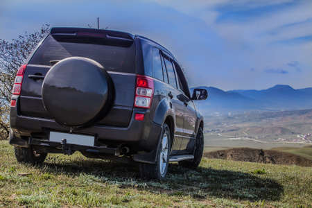 SUV on the field under a cloudy sky. close-up