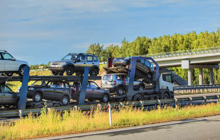 transportation of car on semi-trailer on country highway