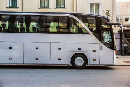Tourist Bus is Moving Down The Street in the Cityの写真素材