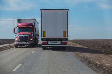 escort of trucks moves on the country highway
