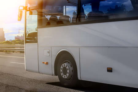 tourist bus is moving down the street in the cityの写真素材