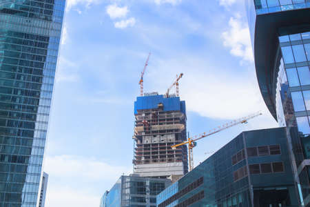 View of multi-storey building under construction and crane in the foreground.の写真素材
