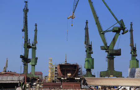 hull of a large sea ship under construction at a shipyardの写真素材
