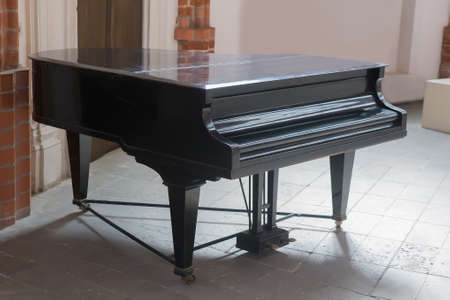 Black shiny grand piano in the big hallの写真素材