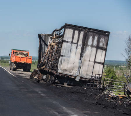Burnt truck on the side of a country highwayの写真素材