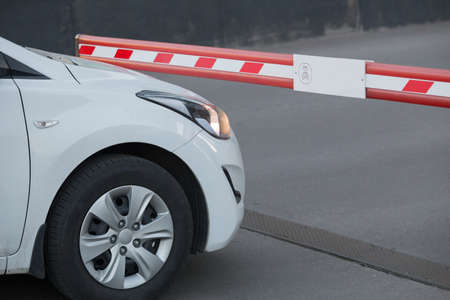 White car in front of the barrier. Detail close-up.