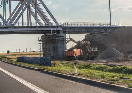 Construction of a new railway bridge over a suburban highwayの写真素材