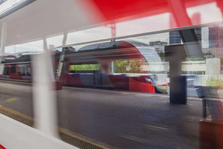 Two modern passenger trains on one platform. Motion blurの写真素材
