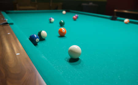 Colored billiard balls on a pool table. Close-up