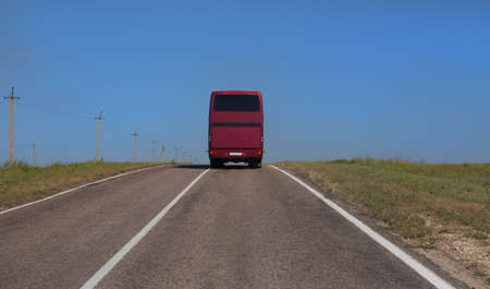 Bus Goes On The Country Highway.Back viewの写真素材