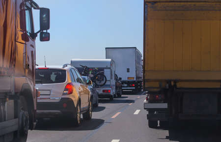 cars in traffic jam on the road under blue skyの写真素材