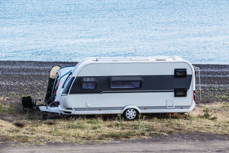 Camper trailer by the sea near the lagoon with cape