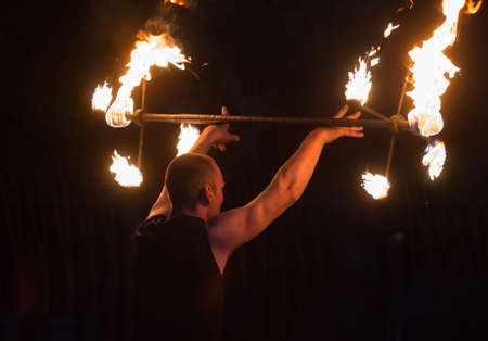 Fakir on fire show in the dark at night