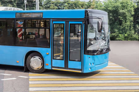 bus moves along a city street at the crossroads. Close-up, detail.の写真素材