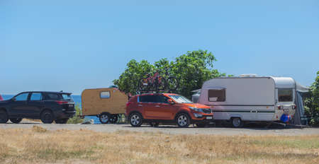 Camping with trailers and cars by the sea in the summer.の写真素材