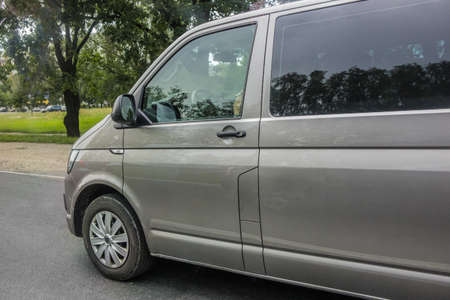 Minibus moves along the city street. Close-up detail.