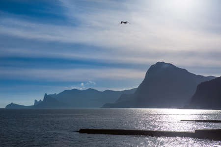 Beautiful cliffs by the sea at sunset in a cloudy sky.の写真素材