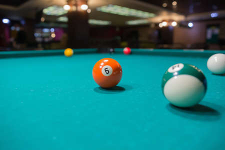 Colored billiard balls on a pool table. Close-up
