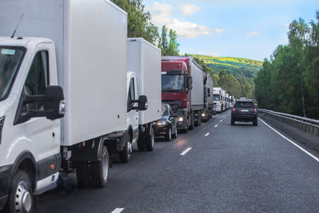Traffic jam on a suburban highway in summer