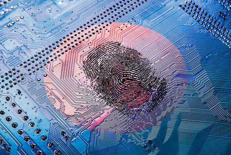 Computer board with a fingerprint in a red circle. Data protection concept.の写真素材