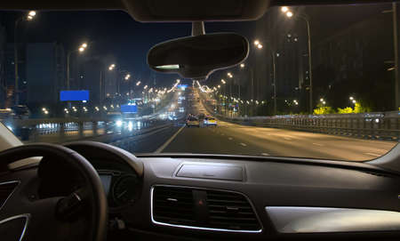 View from driving car on night traffic in city centerの写真素材