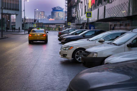 Cars Parked In A Row By The Mall At Dusk