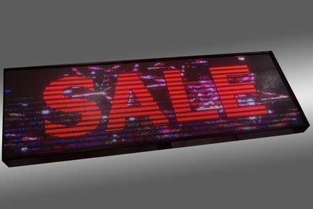 Advertising light diode panel with glowing word SALE isolated on grayの写真素材