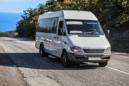 Minibus Moves on the road from the sea in summerの写真素材