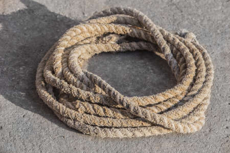 Old hemp rope coiled in a circle close-up