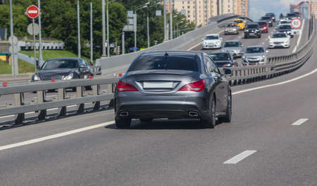 Car Traffic in the City on a Multi-lane Highway on a Summer Day