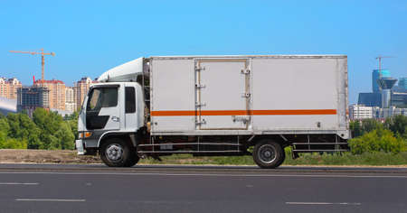 Truck Drives Suburban Highway Sunny Day Cloudy Sky Backgroundの写真素材
