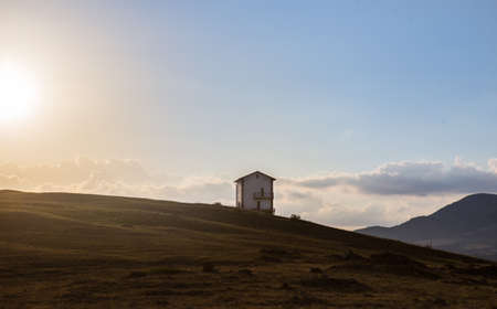 Lonely House on a Hill at Dawn in the Sunlightの写真素材