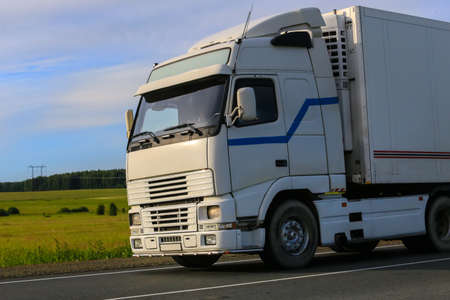 Truck moving along country road. Close-up detail.の写真素材