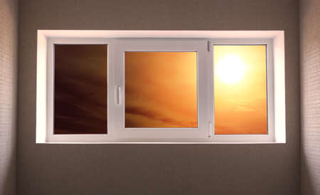 Dramatic red sky with sun in the room window close-up