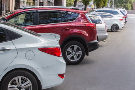 Cars are parked on a city street in the city centerの写真素材