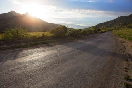 Road to the sea in the mountains at sunset. Scenery.