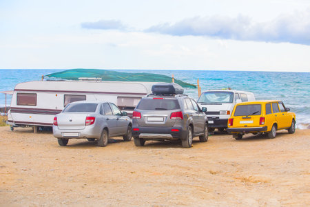 Cars and camper on the seaside on a summer dayの写真素材