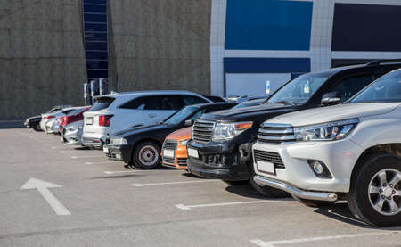 Cars in the Parking Lot in the City near the Shopping Mall