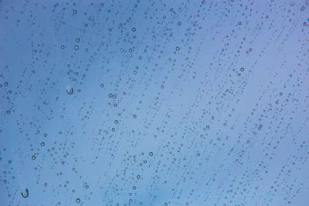 Water Drops on car windshield reflecting the sky